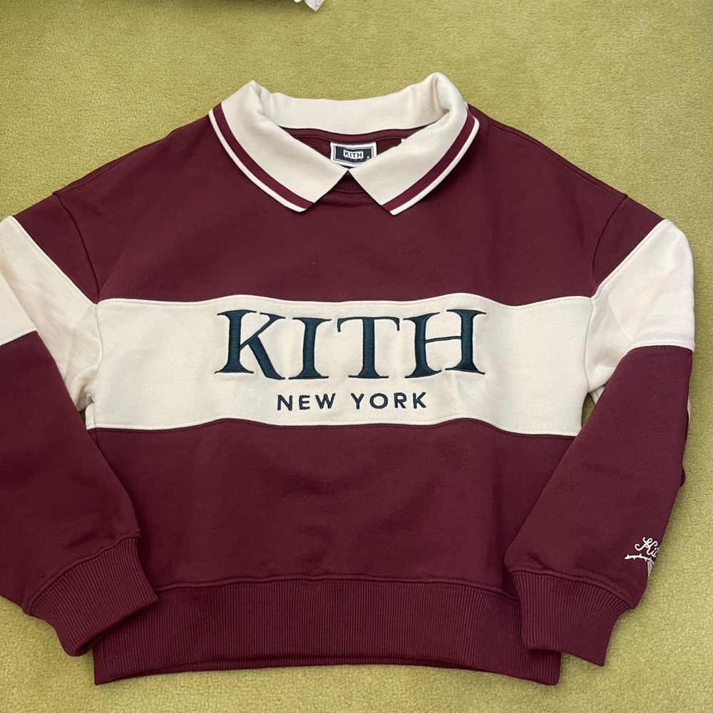 Kith burgundy and white with green writing, collared crewneck
